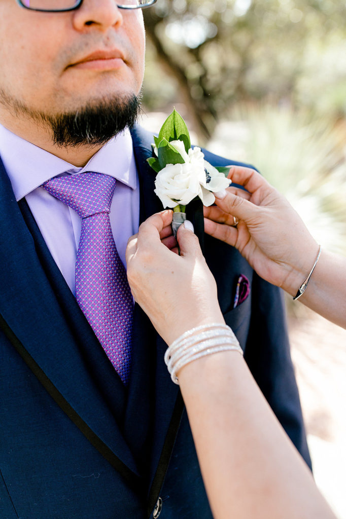 Boutonniere pinning on groom